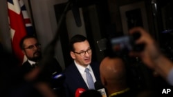 FILE - Polish Prime Minister Mateusz Morawiecki speaks with the media at the end of an EU summit in Brussels, Belgium, Dec. 13, 2019. 