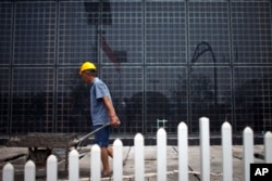 FILE - Solar panels at a factory in Baoding, in northern China's Hebei province. China, the world's largest polluter of climate changing emissions, is aggressively adopting solar energy to cut its dependence on fossil fuels.