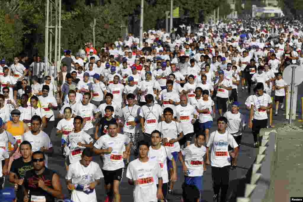 Participants take part in the fourth Amman International Marathon in Amman October 19, 2012