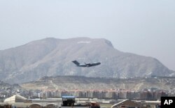 FILE - A US military aircraft takes off at Hamid Karzai International Airport in Kabul, Aug. 28, 2021.