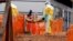FILE - Health workers carry a newly admitted confirmed Ebola patient into a treatment centre in Butembo in the eastern Democratic Republic of Congo.