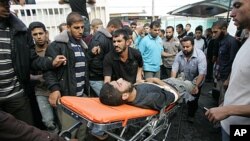 Palestinians wheel into the al-Najar hospital an injured Palestinian militant of Islamic Jihad following an Israeli air strike in the southern Gaza Strip town of Rafah, October 29, 2011.