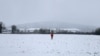 A person walks a snowy field near Darbyshill, Ireland, Jan. 5, 2025.