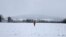 A person walks a snowy field near Darbyshill, Ireland, Jan. 5, 2025.
