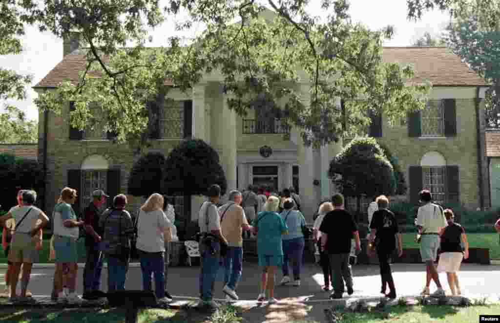 Elvis fans line up in front of Elvis Presley's Graceland Mansion in Memphis August 14 for one of the hundreds of daily tours conducted by Presley's estate.