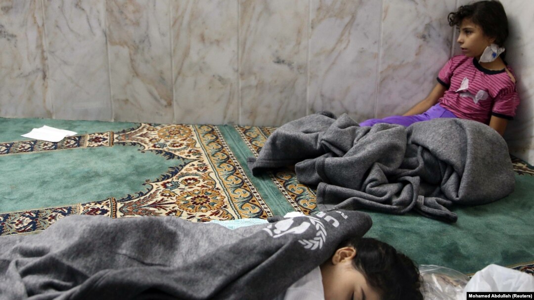Girls who survived from what activists alleged was a gas attack by the Syrian government rest in a mosque in the Duma neighborhood of Damascus on August 21, 2013. 