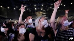 Thousands of concertgoers, masked and tested for the virus, pack AccorHotels Arena in Paris as part of a public health experiment to prepare the country to host big events again, in Paris, May 29, 2021. 