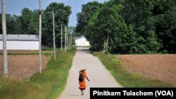 Buddhist monk Sutham Nateetong walks along the road outside Arcola, IN. June 8, 2019.
