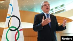 FILE - Thomas Bach, president of the International Olympic Committee, attends an interview after the decision to postpone the 2020 Tokyo Games because of the coronavirus disease outbreak, in Lausanne, Switzerland, March 25, 2020. 