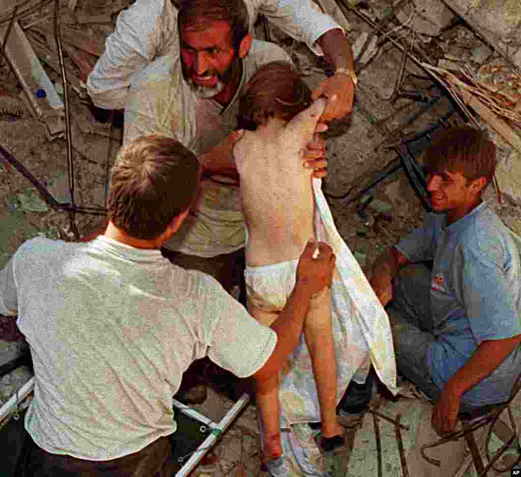 A four-year-old child is rescued from the rubble of the child's home after being trapped for 36 hours following an earthquake, Istanbul, August 19, 1999. (Reuters)