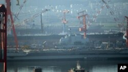 The 300-meter former Soviet carrier, originally called the Varyag, as she is overhauled in the northeast port of Dalian, northwest China's Liaoning province on July 4, 2011.