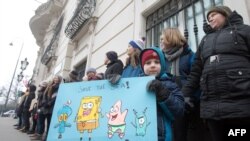 A youth holds a placard during a "Fridays for Future" climate strike outside the Federal Chancellery in Vienna.