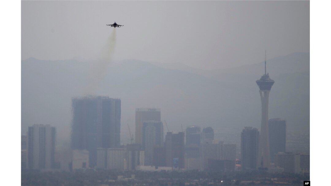 A fighter jet takes off from Nellis Air Force Base as a haze blankets the Las Vegas valley, July 31, 2018, in Las Vegas.