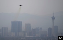 A fighter jet takes off from Nellis Air Force Base as a haze blankets the Las Vegas valley, July 31, 2018, in Las Vegas.