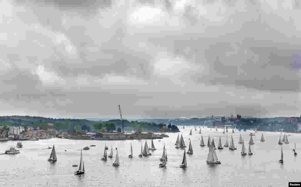 Sailing boats leave Stockholm harbor for the start of the annual AF Offshore Race. 