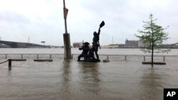 A statue of explorers Lewis and Clark is surrounded by floodwater along the St. Louis riverfront, May 2, 2019. Several Mississippi River towns are seeing floods that are closing in on the historic levels reached in 1993.