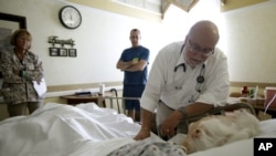 Dr. Joel Policzer checks on a patient in the hospice department of a hospital in Oakland Park, Florida. 