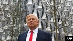 A Madame Tussauds wax figure of US President Donald Trump stands outside the new US Embassy in Embassy Gardens in south-west London on Jan. 12, 2018.
