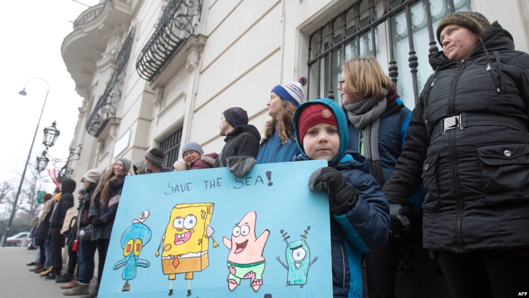 A youth holds a placard during a "Fridays for Future" climate strike outside the Federal Chancellery in Vienna.
