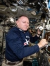 NASA astronaut Butch Wilmore shows research hardware for a study that explores 3D printing of on-demand medical devices on the International Space Station on Dec. 2, 2024.