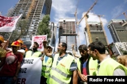 Workers shout slogans during a protest in front of an residential project, where an accident occurred in Istanbul, Turkey, Sept. 8, 2014.