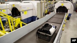 FILE - Luggage emerges on a conveyer belt after passing through a CTX scanner at John F. Kennedy International Airport in New York, Oct. 30, 2014. North Korea accuses U.S. officials at the airport of having illegally seized a package from one of its delegations, a charge U.S. officials deny, saying the package in question had no diplomatic protection.