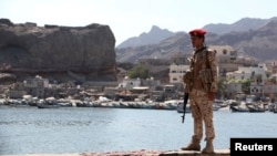 A soldier allied to Yemen's internationally recognized government stands guard at the fish market in Aden, Yemen, Dec. 13, 2018. 