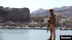 A soldier allied to Yemen's internationally recognized government stands guard at the fish market in Aden, Yemen, Dec. 13, 2018. 