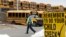 FILE - A driver walks away from the school bus parking lot after his morning shift, in Omaha, Nebraska. 