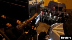 Anti-fascist demonstrators shout as an Italian police van carries the coffin of Nazi war criminal Erich Priebke, in Albano Laziale near Rome, Oct. 16, 2013.