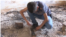 Noeh Binoo, 13, squats to collect remains of his marbles in what used to be his bedroom before Islamic State militants torched it three years ago, Aug. 2017. (Open Doors USA photo) 