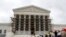 FILE - Visitors to the Supreme Court are pictured in the rain in Washington.