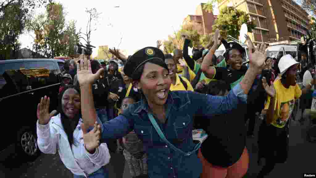 Supporters sing as they pay their respects to ailing Mandela.