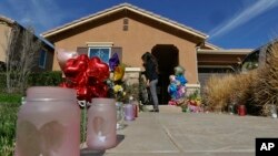Neighbors write messages for the Turpin children on the front door of the home of David and Louise Turpin, where police arrested the couple accused of holding 13 children captive in Perris, Calif., Jan. 24, 2018.
