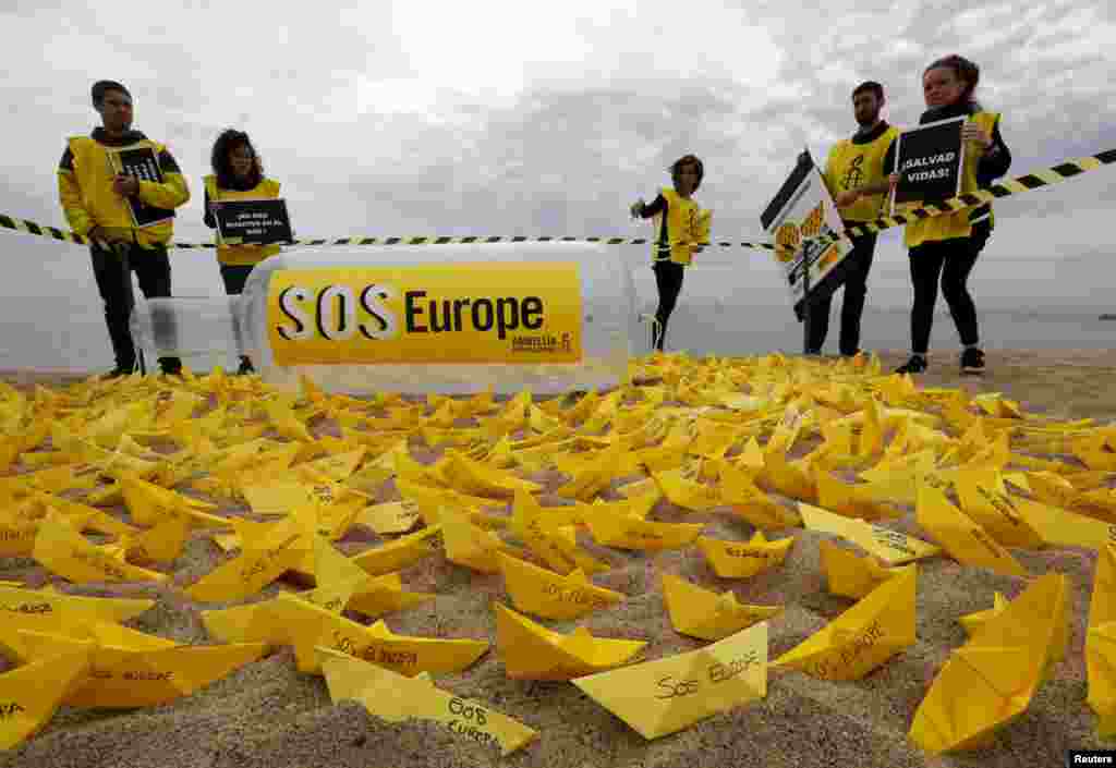 Sukarelawan Amnesty International meletakkan ratus perahu kertas &quot;SOS Europe&quot; di pantai San Sebastian di Barcelona, Spanyol. Protes tersebut menyerukan Uni Eropa untuk memperhatikan krisis imigrasi di Mediterania, setelah ratusan migran tenggelam ketika berusaha untuk datang ke Eropa beberapa hari terakhir.