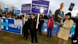 FILE - Supporters for Hillary Clinton, Bernie Sanders and Martin O’Malley rally outside the Dec. 19 Democratic presidential debate in Manchester, N.H.