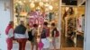 Window shoppers look into a store in Miami Beach, Florida, April 26, 2017.