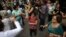 FILE - Elderly people dance on a street during the International Day of Older Persons in Sao Paulo's Avenida Paulista, Brazil, October 2013.