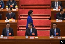 Newly-named Chinese vice Premier Liu Yandong walks past top leaders, including (front row from left to right), National People's Congress chairman Zhang Dejiang and Chinese President Xi Jinping, in Beijing's Great Hall of the People, China, March 16, 2013.