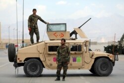 FILE - Afghan army soldiers stand guard after American troops left Bagram air base, in Parwan province, north of Kabul, Afghanistan, July 5, 2021.