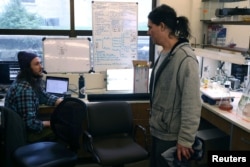 Senior Research Scientist Jason Hodin of the University of Washington’s Friday Harbor Marine Lab speaks with research assistant and diver Joey Ullmann inside the lab at the university’s field station in Friday Harbor, Washington, U.S., February 11, 2023. (REUTERS/Matt Mills McKnight)