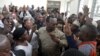 FILE - Freeman Mbowe, center, chairman of Chadema, Tanzania's main opposition party, arrives at Kisutu Magistrate Court in Dar es Salaam, Tanzania, March 10, 2020. 
