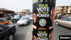 FILE- Election posters along a road on the last day of voter registration exercises in Nigeria's commercial capital, Lagos, Feb. 5, 2011.