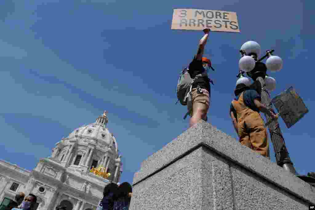 A demonstrator protests outside the state Capitol, Sunday, May 31, 2020, in Minneapolis.