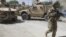 A US soldier, part of the NATO forces, patrols a police station after it was attacked by militants, Kandahar, Afghanistan, June 19, 2012.