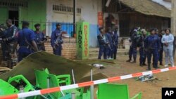 An area is cordoned off as police officers inspect the scene of a bomb explosion in Beni, eastern Congo, Dec. 26, 2021.