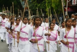 FILE - Indian female volunteers of the right-wing Hindu nationalist group Rashtriya Swayamsevak Sangh (RSS) take part in a procession after they completed their training, in Siliguri, May 25, 2019.