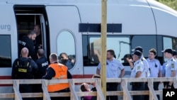 FILE - A small girl cries as she is removed by the police from an train in Rodbyhavn, approximately 5 km southwest of the town of Roedby, Denmark, Sept. 9, 2015.