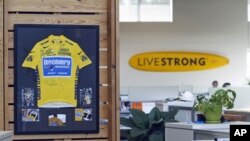 An autographed cycling jersey hangs in the offices of Livestrong, Lance Armstrong's cancer-fighting charity, October 17, 2012, in Austin, Texas. 