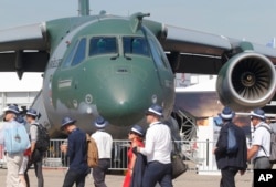 Visitors walk past a Embraer KC-390 military transport aircraft built by Brazilian aerospace manufacturer Embraer at the Paris Air Show, in Le Bourget, east of Paris, June 20, 2017.
